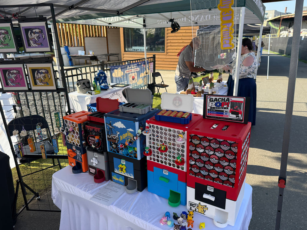 Real GachaPop machines on display at our convention booth, including Horror Mystery Machine, The Grand Voyage, and Mario/Pokémon builds